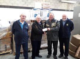 Rotarians John Green presenting Rev Bernard Crocker from International Aid Trust with cheque